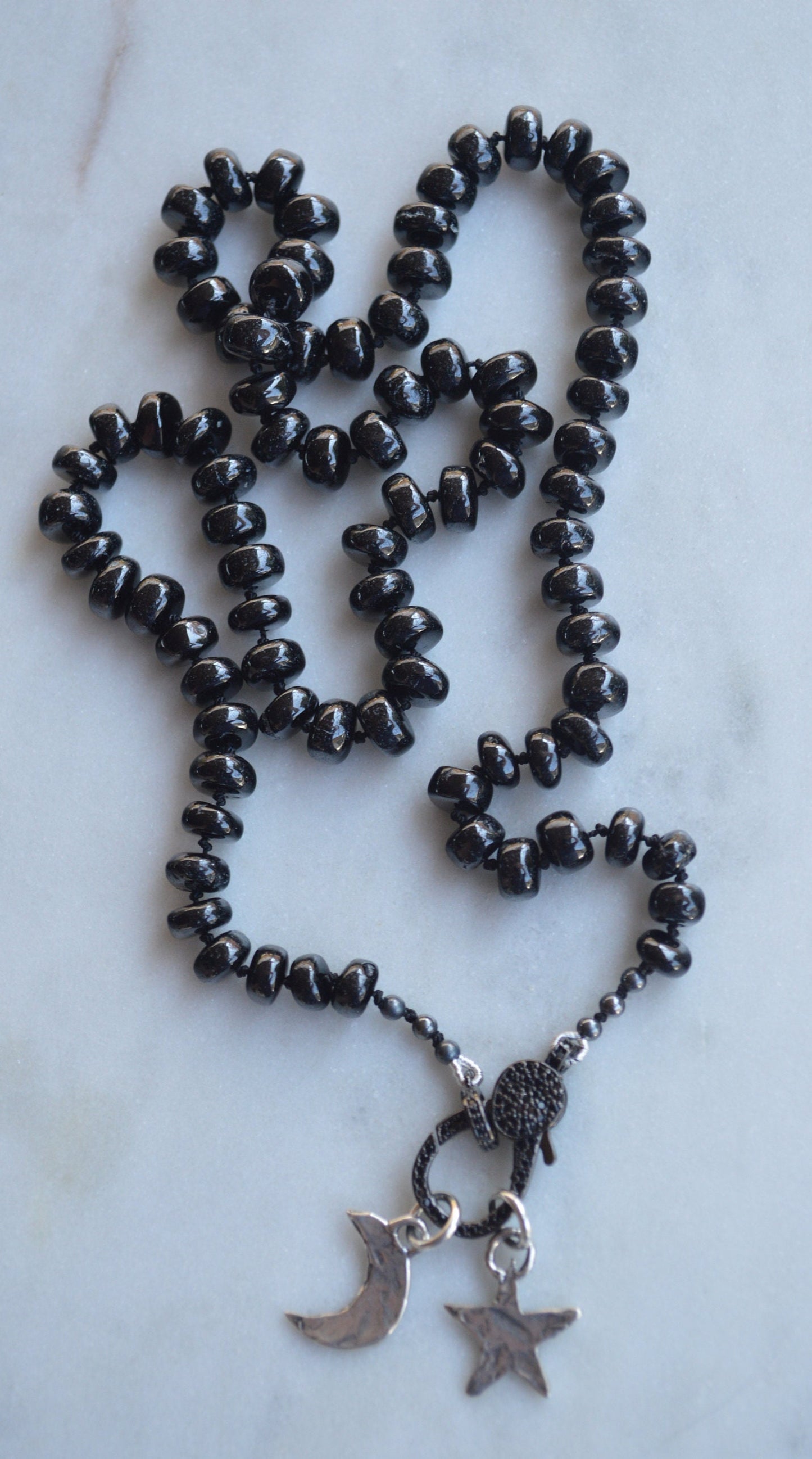 23" Black Spinel Smooth Rondelle Gemstones Hand Knotted On Black Silk. Black CZ Lobster Clasp Can Be Worn in Back or Front With Charms