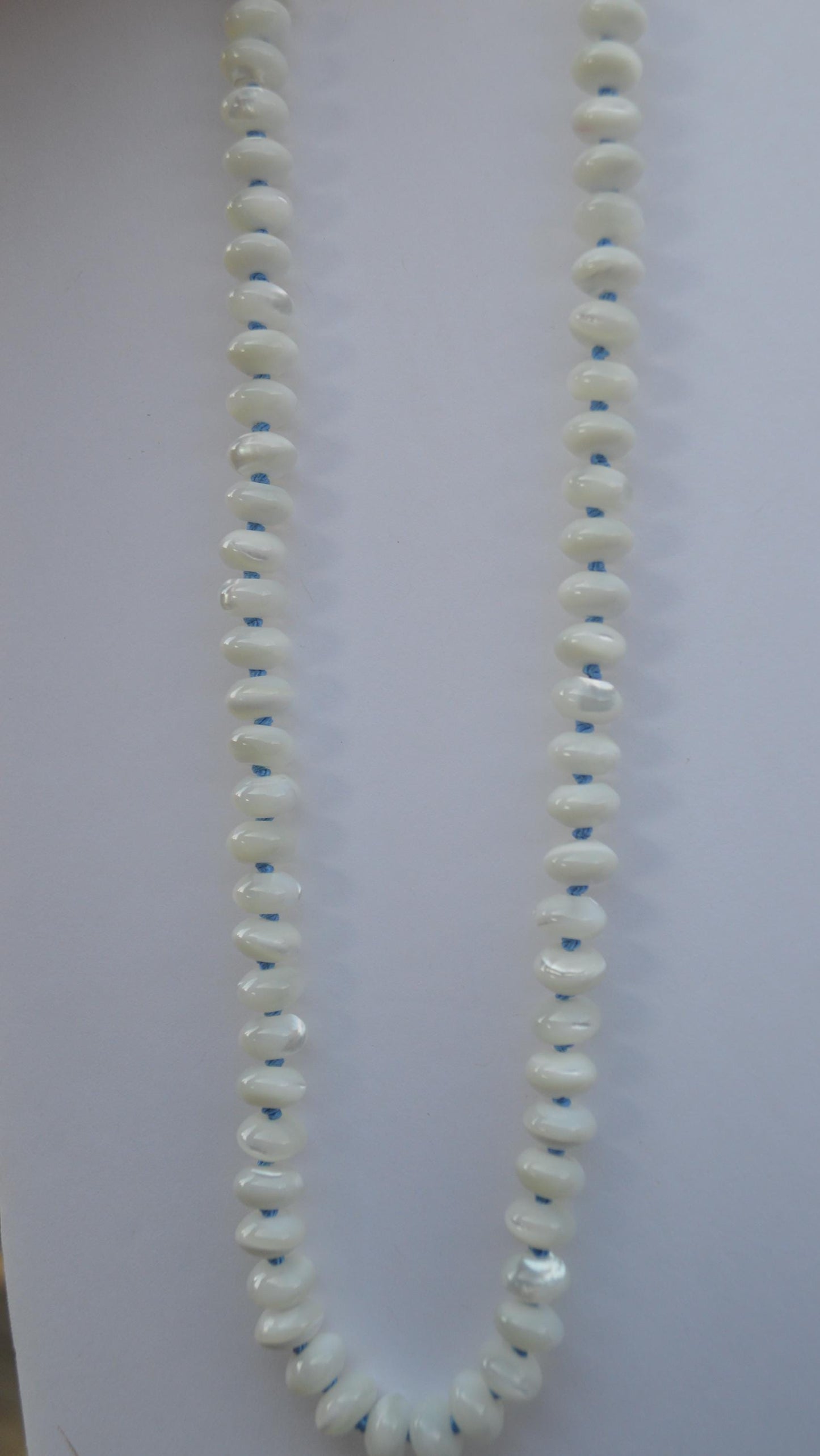 Shimmery Mother of Pearl 8mm Rondelle Necklace Hand Knotted on Sky Blue Silk. Hand Forged Sterling Hook and Eye Clasp