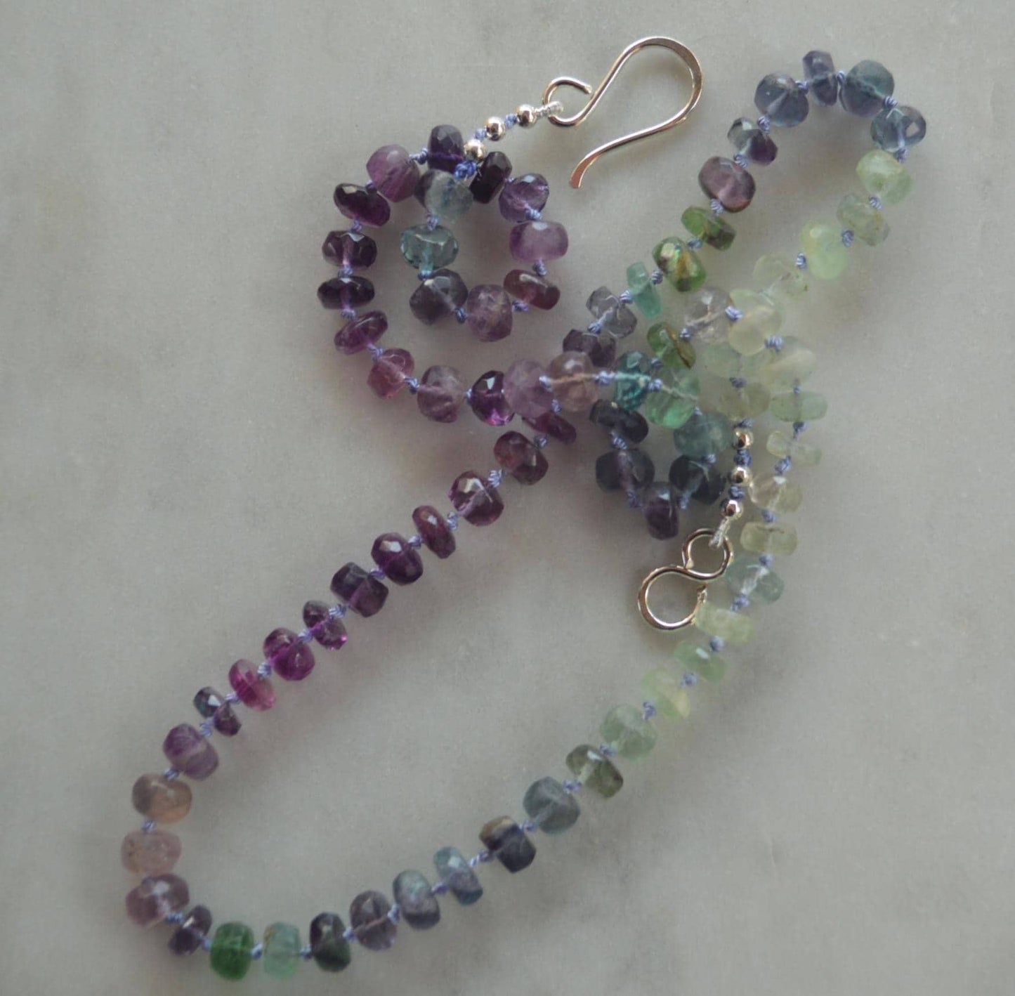 Beautiful 21" Flourite Faceted Rondelle Necklace Hand Knotted on Lavender Silk. Sterling Silver Hand Forged Hook and Eye Clasp