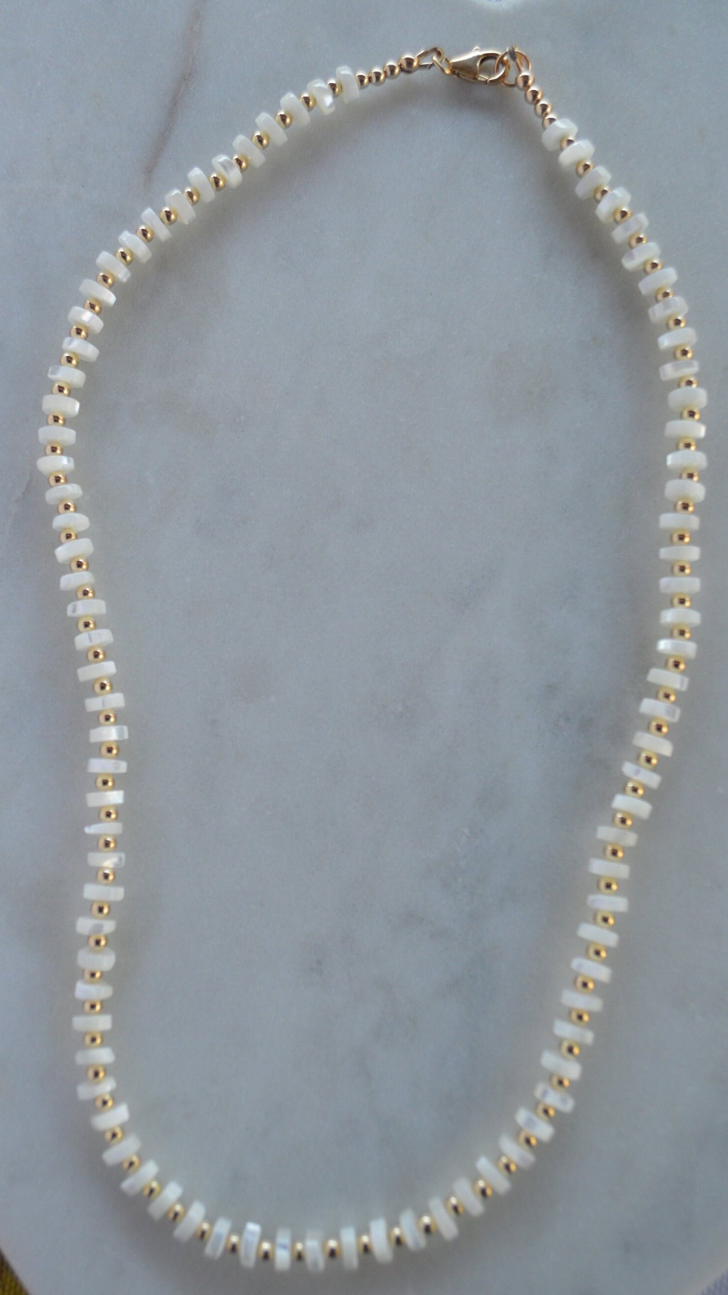 Luminous and Iridescent Mother of Pearl Heishi Necklace with 18K Gold Filled Beads and Lobster Clasp.  18", 6mm Round Shells