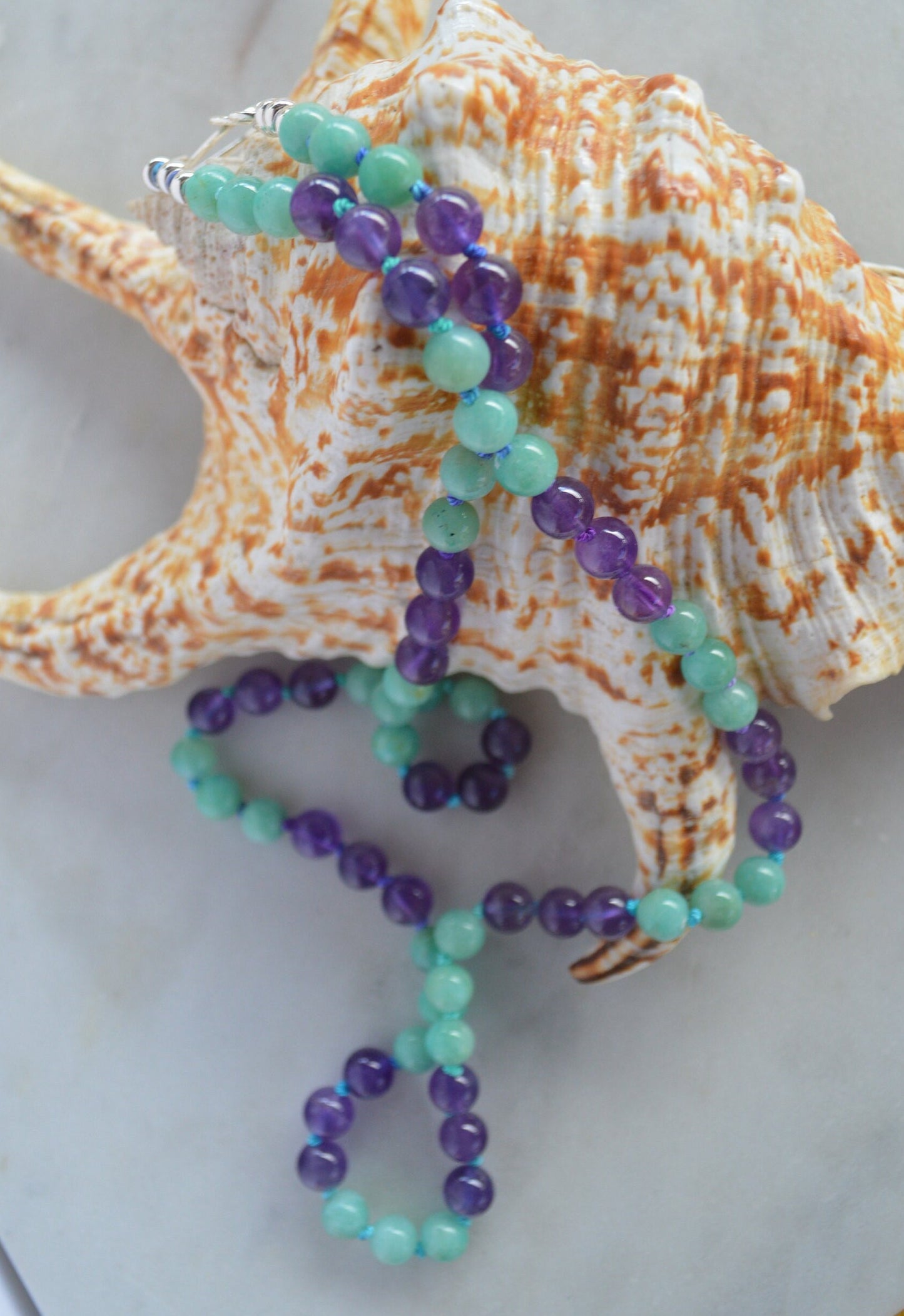 Hand Knotted Natural Amazonite and Amethyst Beads on Teal and Turquoise Silk Thread.  Hand Forged Sterling Hook and Eye Clasp and Beads. 21"