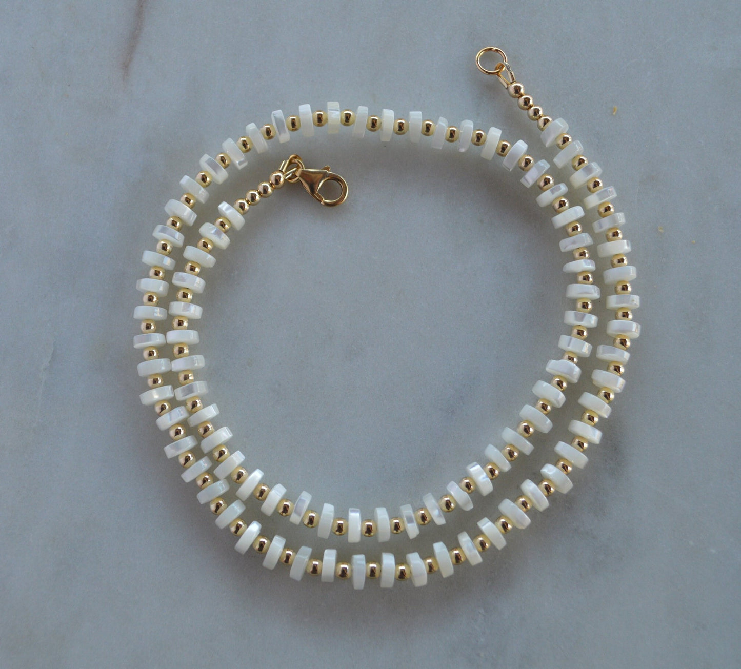 Luminous and Iridescent Mother of Pearl Heishi Necklace with 18K Gold Filled Beads and Lobster Clasp.  18", 6mm Round Shells