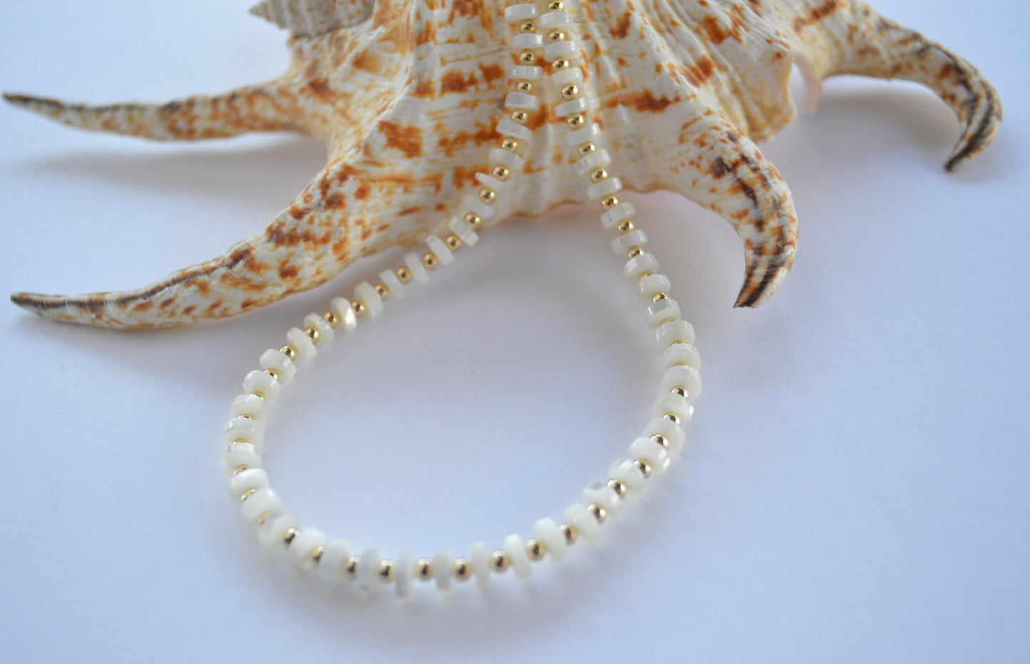 Luminous and Iridescent Mother of Pearl Heishi Necklace with 18K Gold Filled Beads and Lobster Clasp.  18", 6mm Round Shells