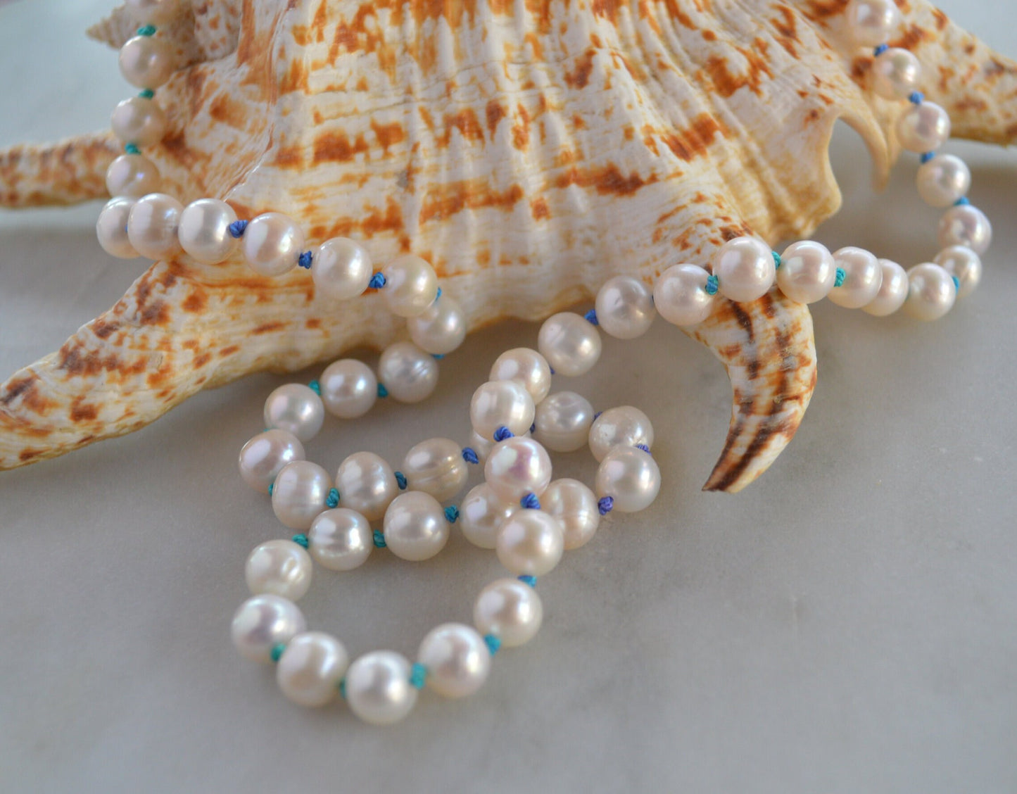 Luminescent 7-8mm Pearls Hand Knotted on Teal and Purple Silk Thread.  Hand Forged Sterling Silver Hook and Eye Clasp. 20"