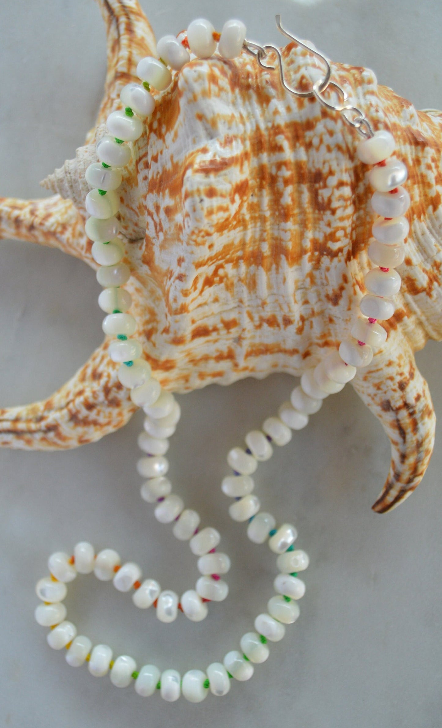 Iridescent AAA Natural White Mother of Pearl 8mm Rondelle Beaded Necklace Hand Knotted on Multi Colored Silk Thread. Sterling Hook and Eye.