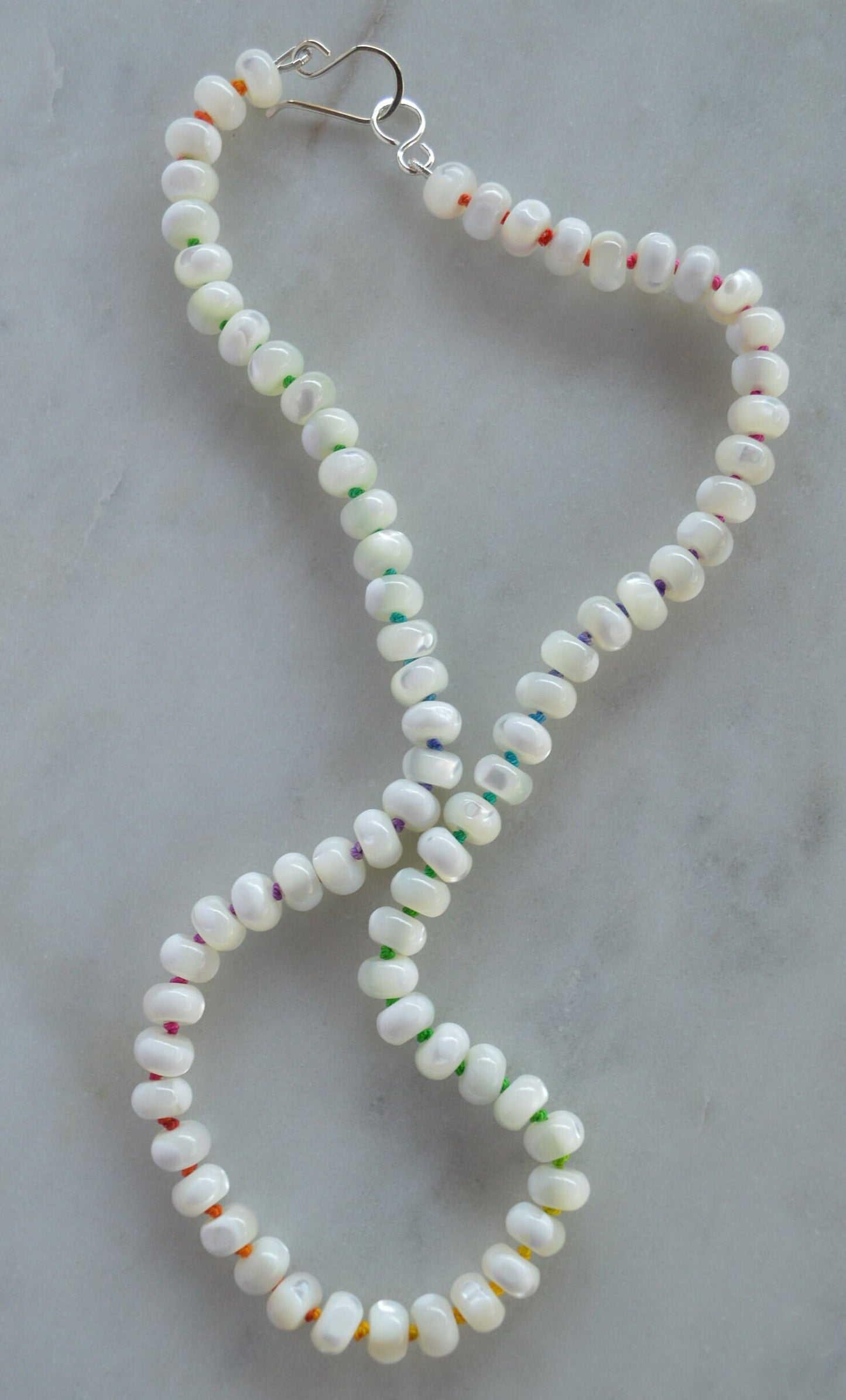 Iridescent AAA Natural White Mother of Pearl 8mm Rondelle Beaded Necklace Hand Knotted on Multi Colored Silk Thread. Sterling Hook and Eye.