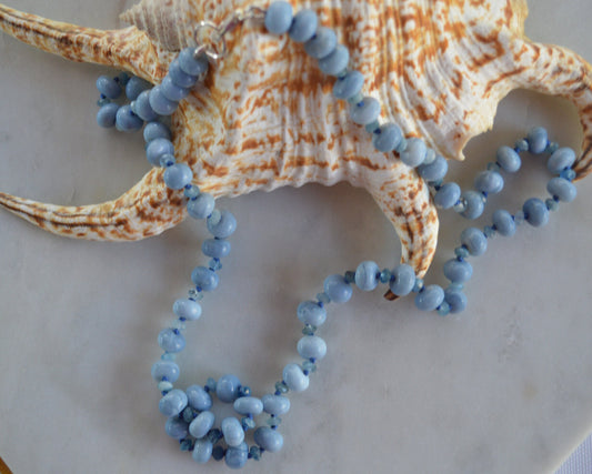 Sky Blue Smooth Opal Rondelles and Stormy Blue Aquamarine Gemstones Hand knotted on Blue Silk.  Sterling Lobster Clasp. 22"