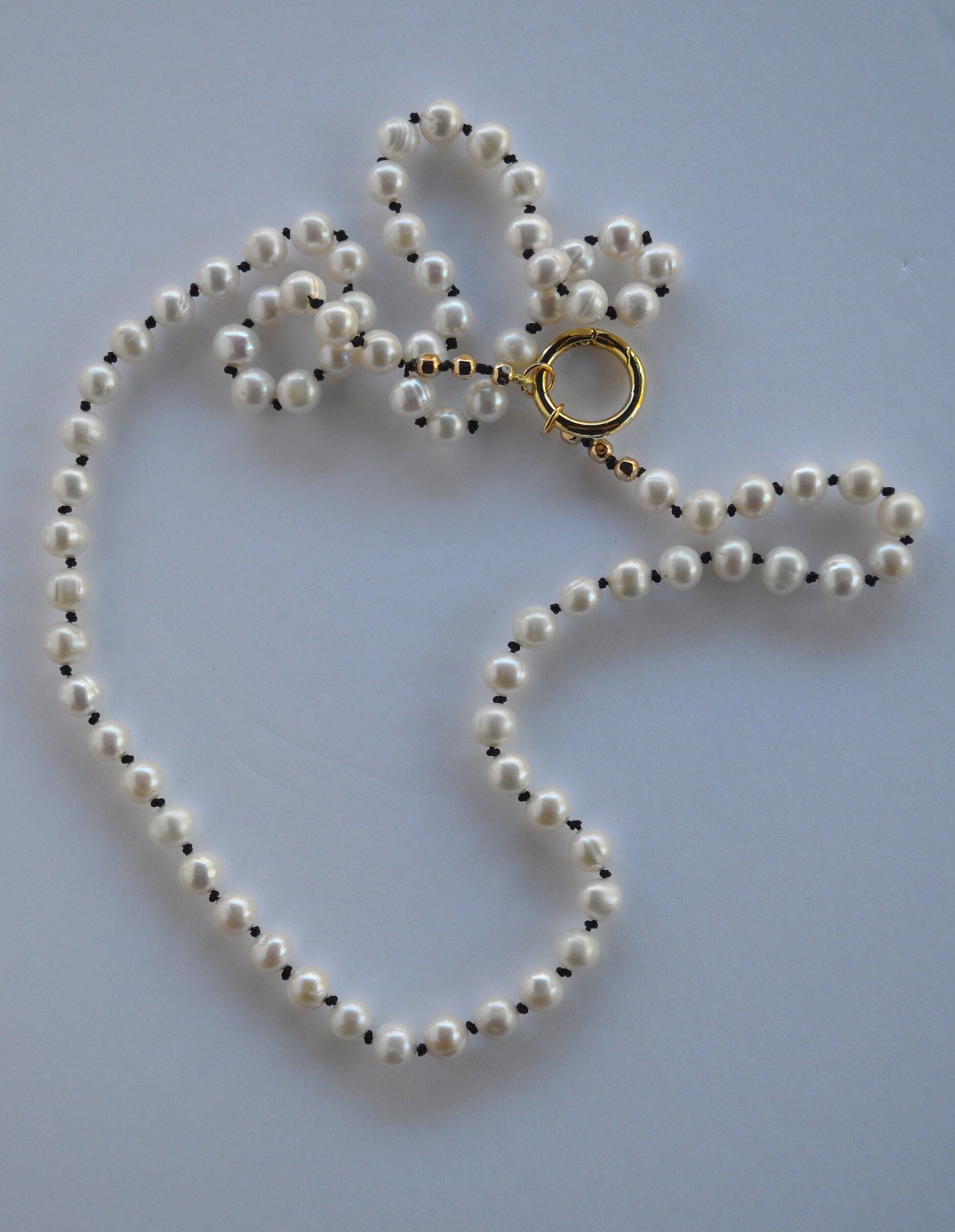 Beautiful Freshwater Pearls Hand Knotted on Black Silk. Gold Filled Interchangeable Clasp Can Be Worn In the Back or Front.