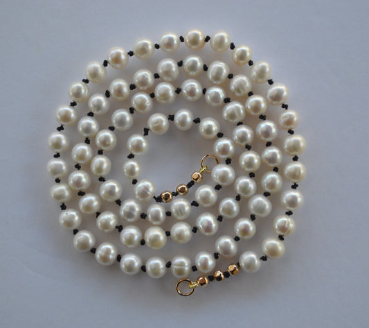 Beautiful Freshwater Pearls Hand Knotted on Black Silk. Gold Filled Interchangeable Clasp Can Be Worn In the Back or Front.