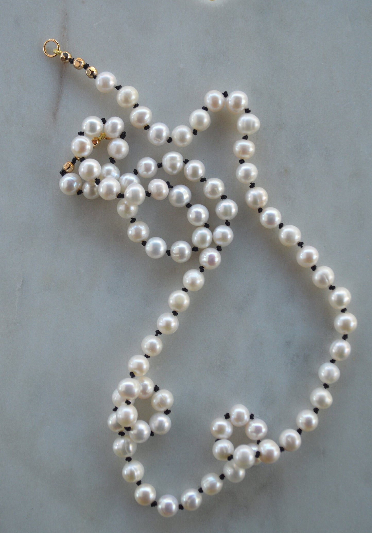 Beautiful Freshwater Pearls Hand Knotted on Black Silk. Gold Filled Interchangeable Clasp Can Be Worn In the Back or Front.