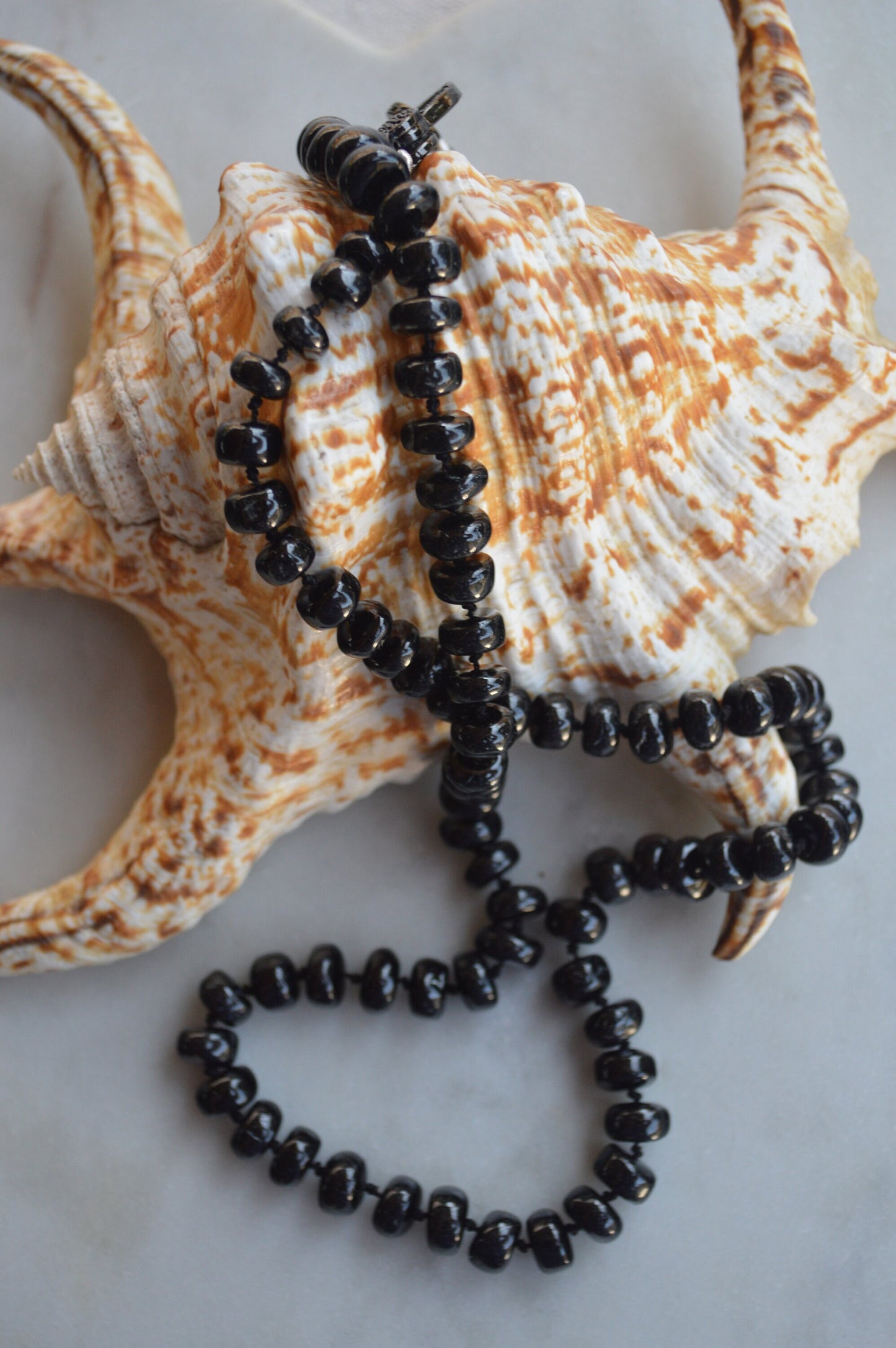 23" Black Spinel Smooth Rondelle Gemstones Hand Knotted On Black Silk. Black CZ Lobster Clasp Can Be Worn in Back or Front With Charms