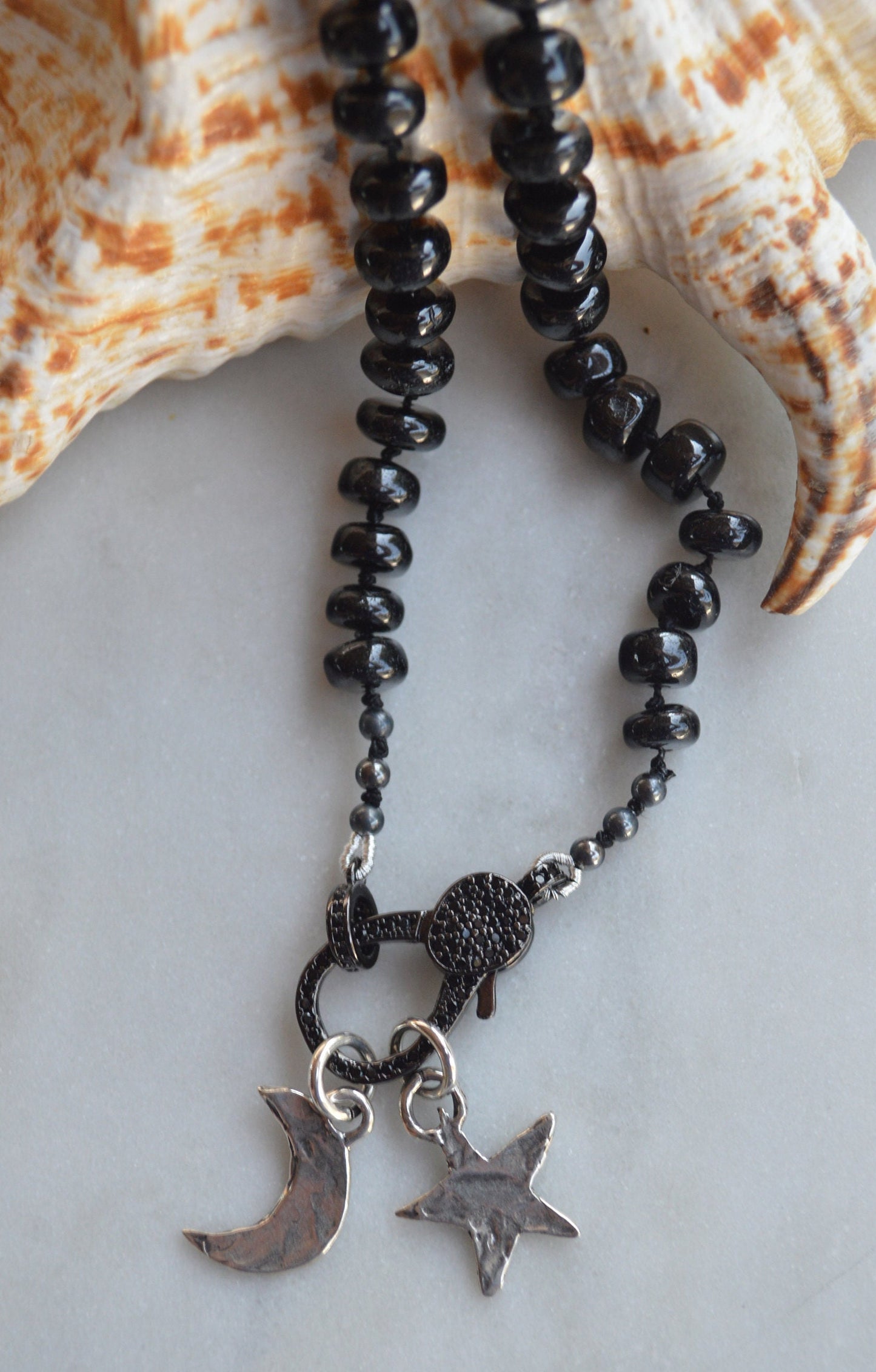 23" Black Spinel Smooth Rondelle Gemstones Hand Knotted On Black Silk. Black CZ Lobster Clasp Can Be Worn in Back or Front With Charms