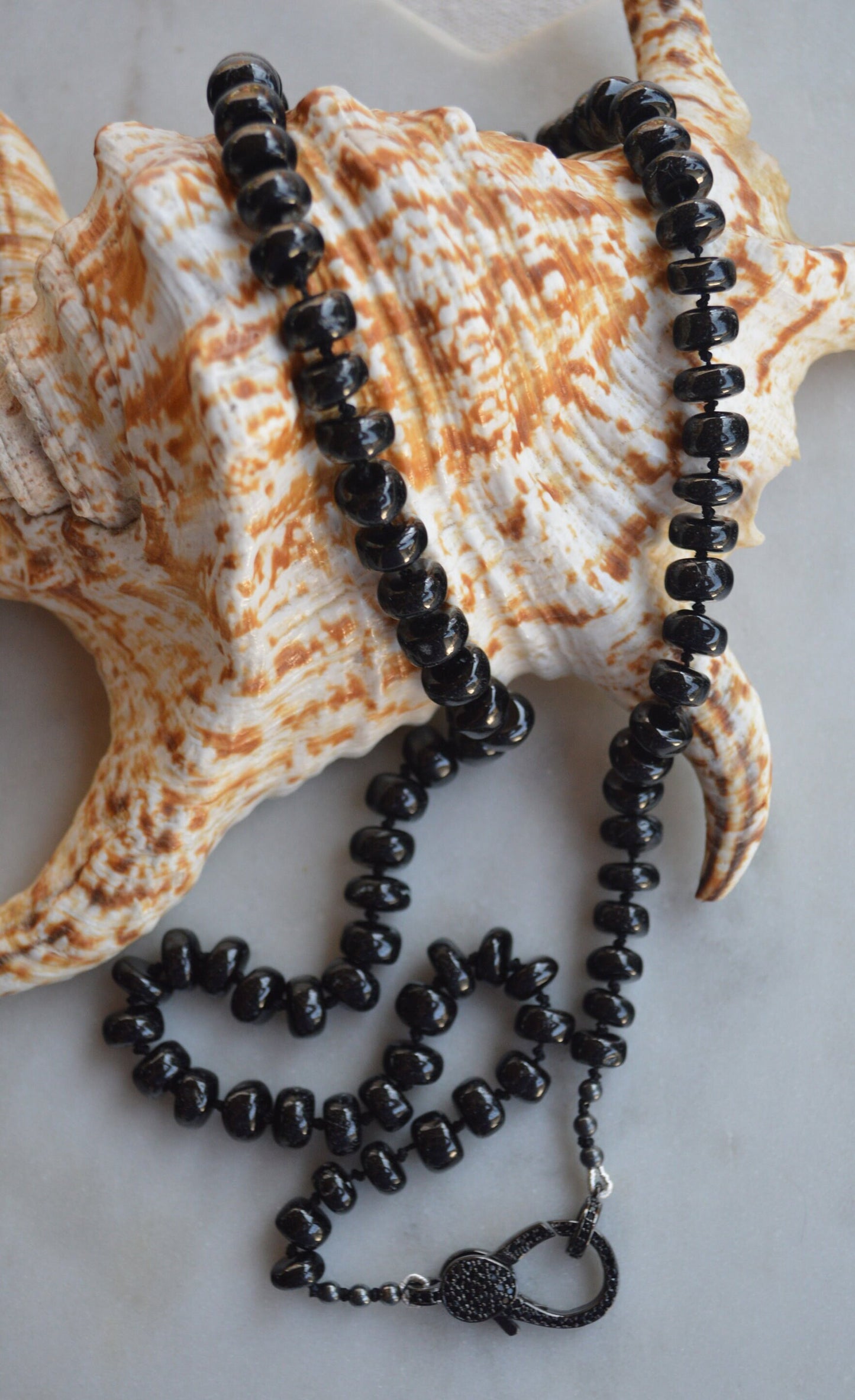 23" Black Spinel Smooth Rondelle Gemstones Hand Knotted On Black Silk. Black CZ Lobster Clasp Can Be Worn in Back or Front With Charms