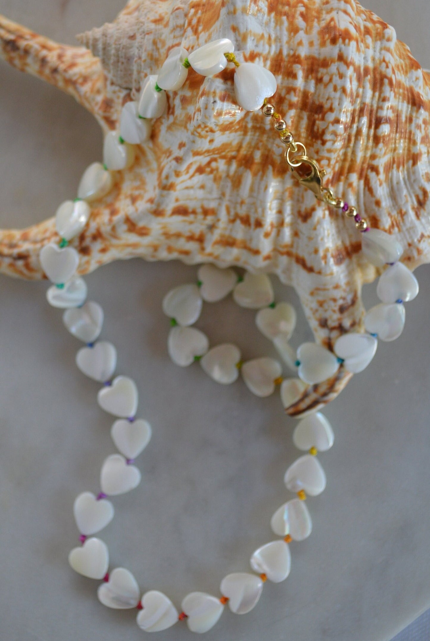 Shimmery and Iridescent Necklace.  Mother of Pearl Heart Beads Knotted on Multicolored Silk.  GF Italian Lobster Claw and Beads. 19"