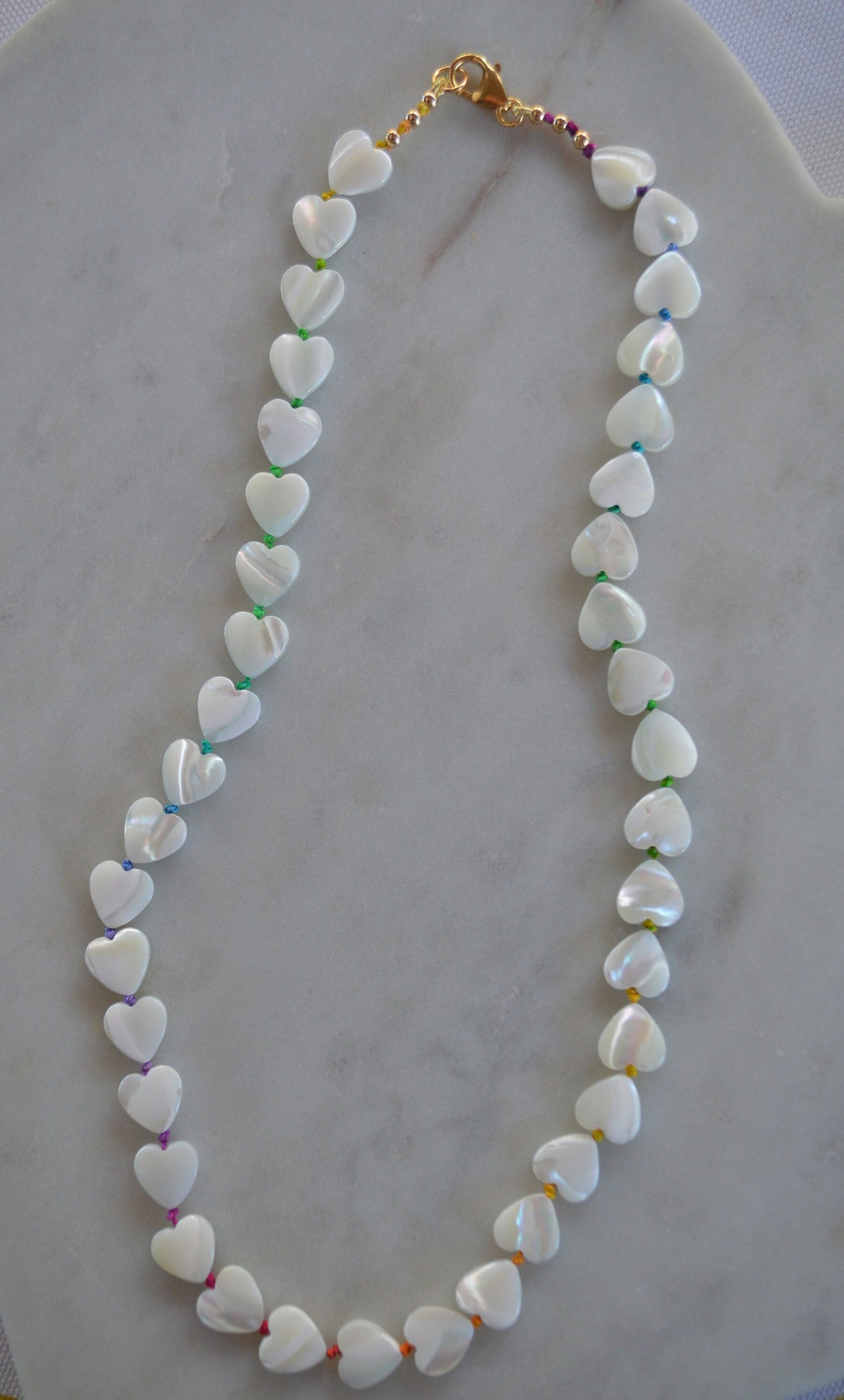 Shimmery and Iridescent Necklace.  Mother of Pearl Heart Beads Knotted on Multicolored Silk.  GF Italian Lobster Claw and Beads. 19"