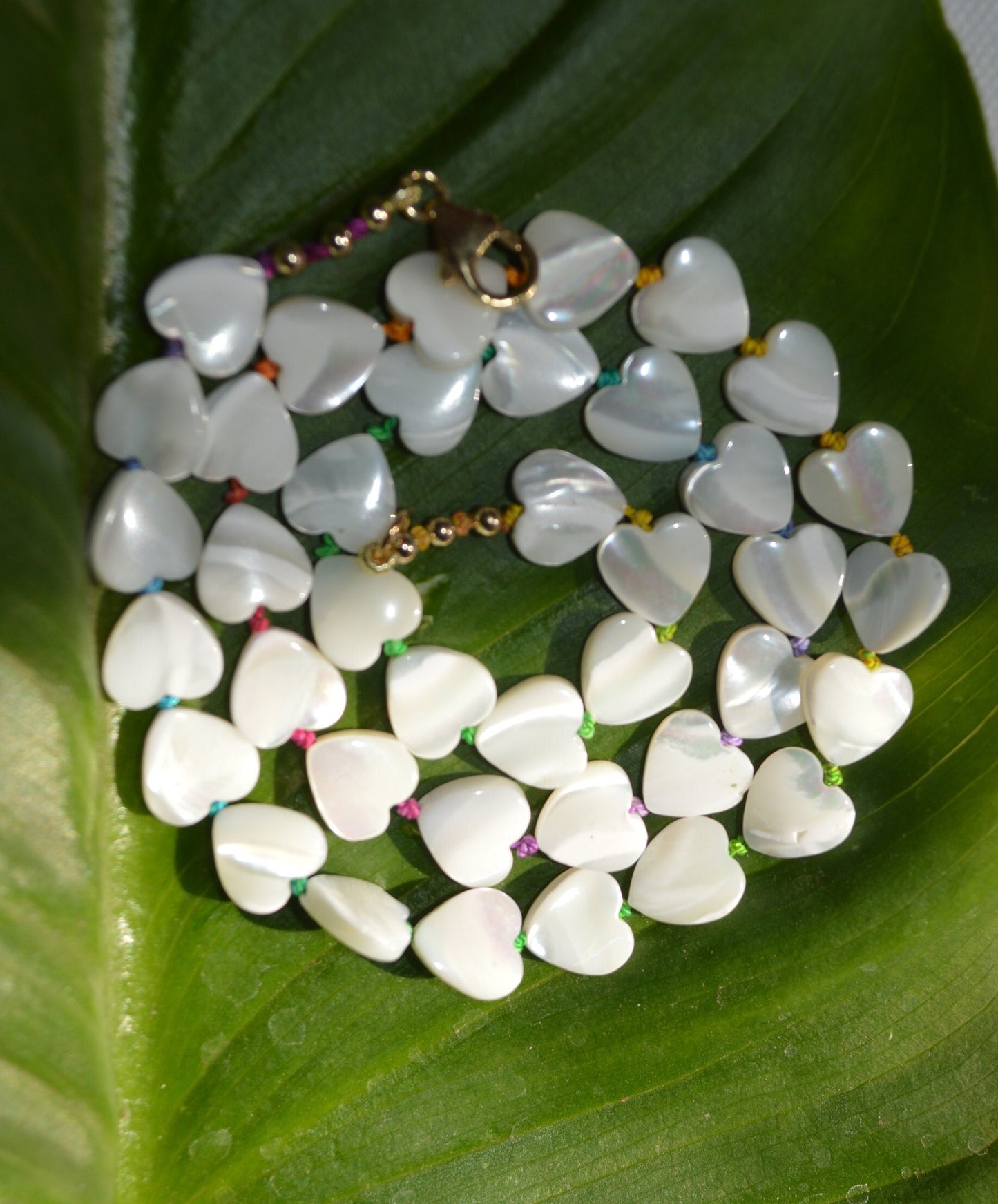 Shimmery and Iridescent Necklace.  Mother of Pearl Heart Beads Knotted on Multicolored Silk.  GF Italian Lobster Claw and Beads. 19"
