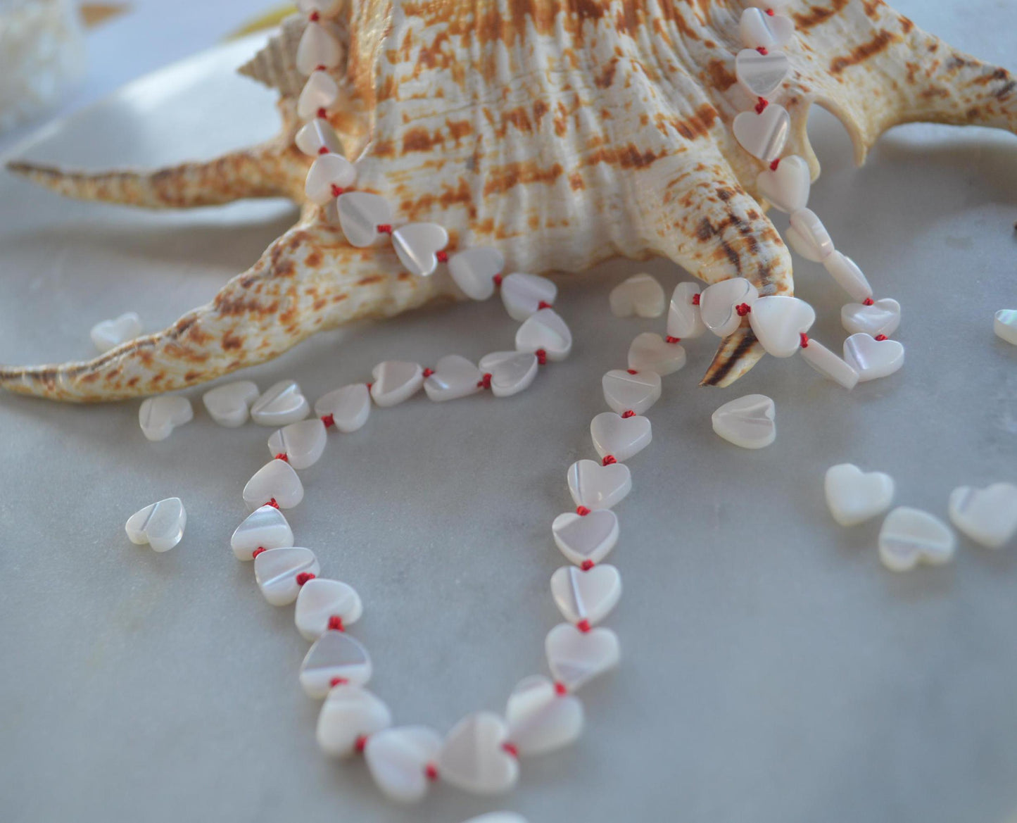 Beautiful 20" Mother of Pearl Hearts Hand Knotted on Red Silk. Sterling Silver Lobster Clasp. A Great Valentine's Day Gift For Her