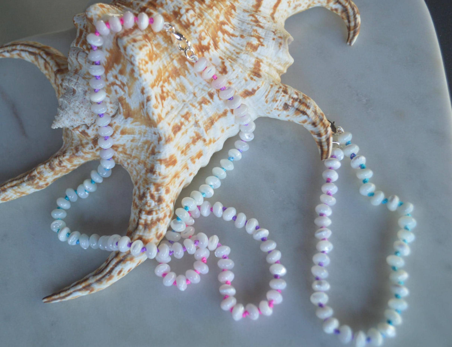 19" Mother of Pearl Rondelles Hand Knotted on Custom Fushia, Teal and Purple Silk. Sterling Lobster Clasp and Beads