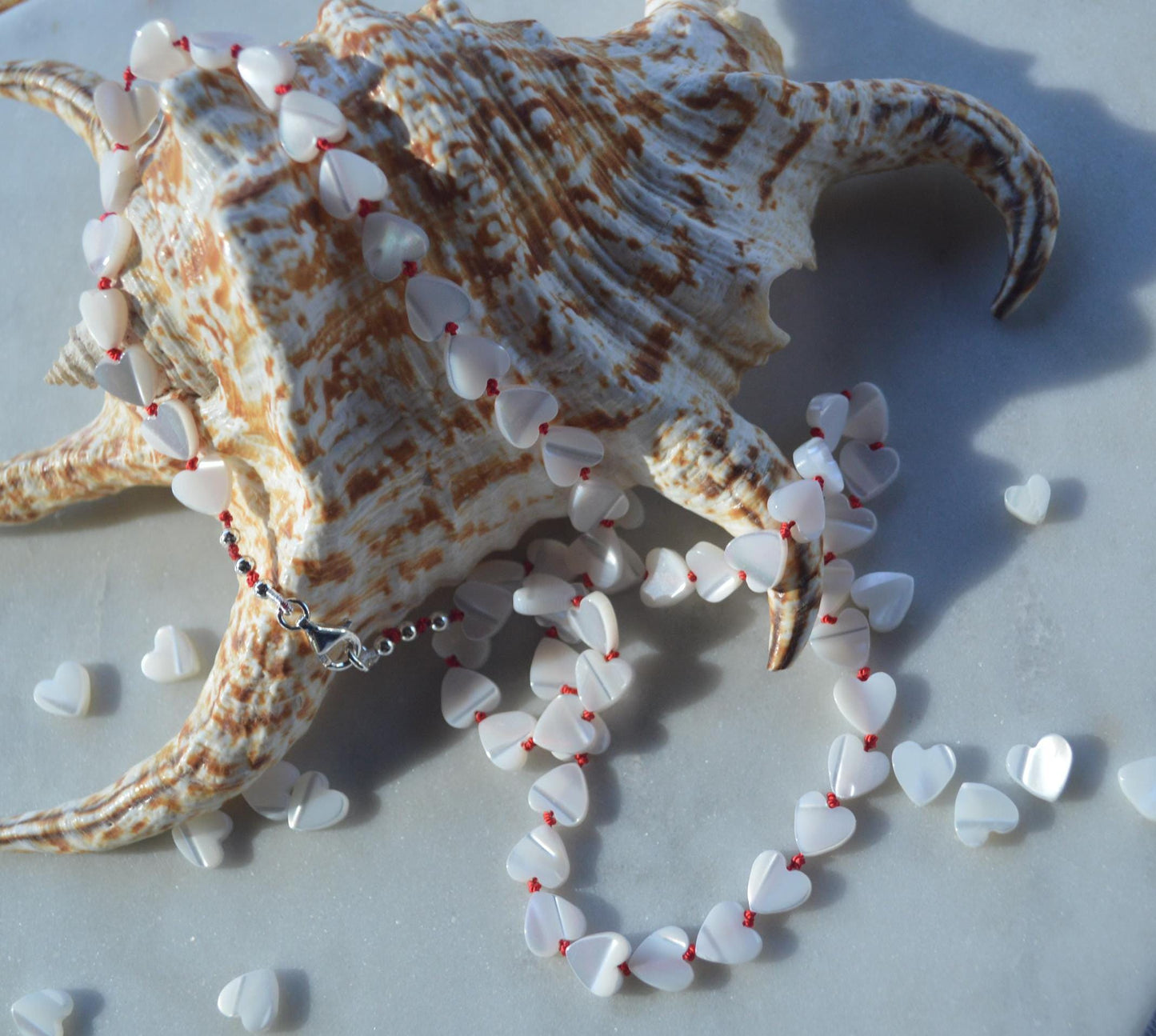 Beautiful 20" Mother of Pearl Hearts Hand Knotted on Red Silk. Sterling Silver Lobster Clasp. A Great Valentine's Day Gift For Her
