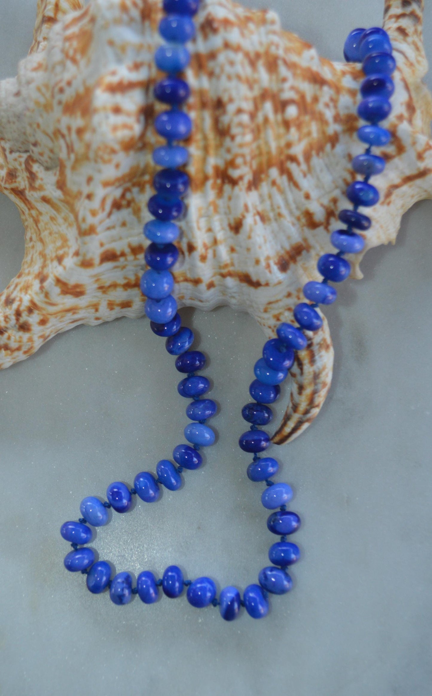 18" Cobalt Blue Smooth Opal Rondelles Hand Knotted on Dark Blue Silk.  This Versatile Piece is Finished with a Sterling Silver Lobster Clasp