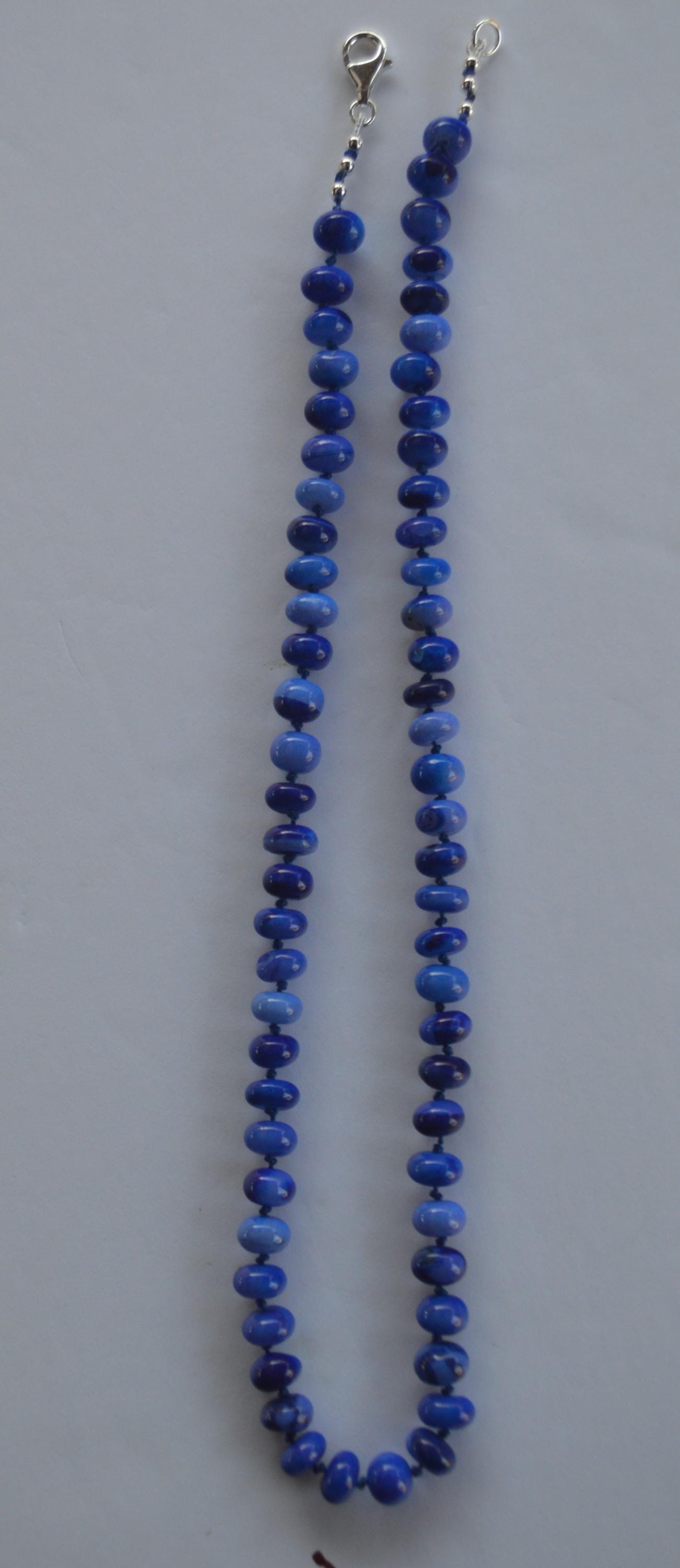 18" Cobalt Blue Smooth Opal Rondelles Hand Knotted on Dark Blue Silk.  This Versatile Piece is Finished with a Sterling Silver Lobster Clasp