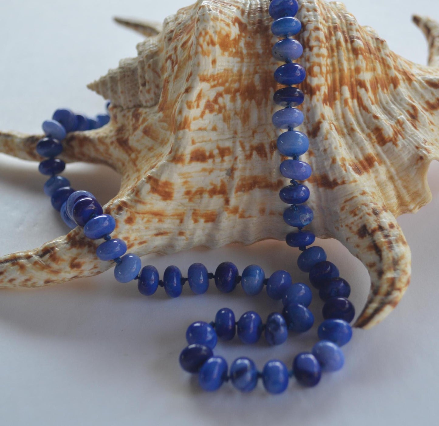 18" Cobalt Blue Smooth Opal Rondelles Hand Knotted on Dark Blue Silk.  This Versatile Piece is Finished with a Sterling Silver Lobster Clasp