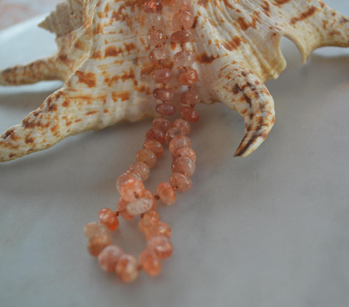 Natural 7mm Sunstone Gemstones Hand Knotted on Coral Silk.  This Piece is Finished with a Hand Forged GF Hook & Eye Clasp. 18.5" Long.