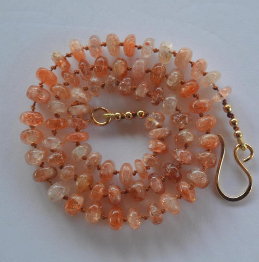 Natural 7mm Sunstone Gemstones Hand Knotted on Coral Silk.  This Piece is Finished with a Hand Forged GF Hook & Eye Clasp. 18.5" Long.