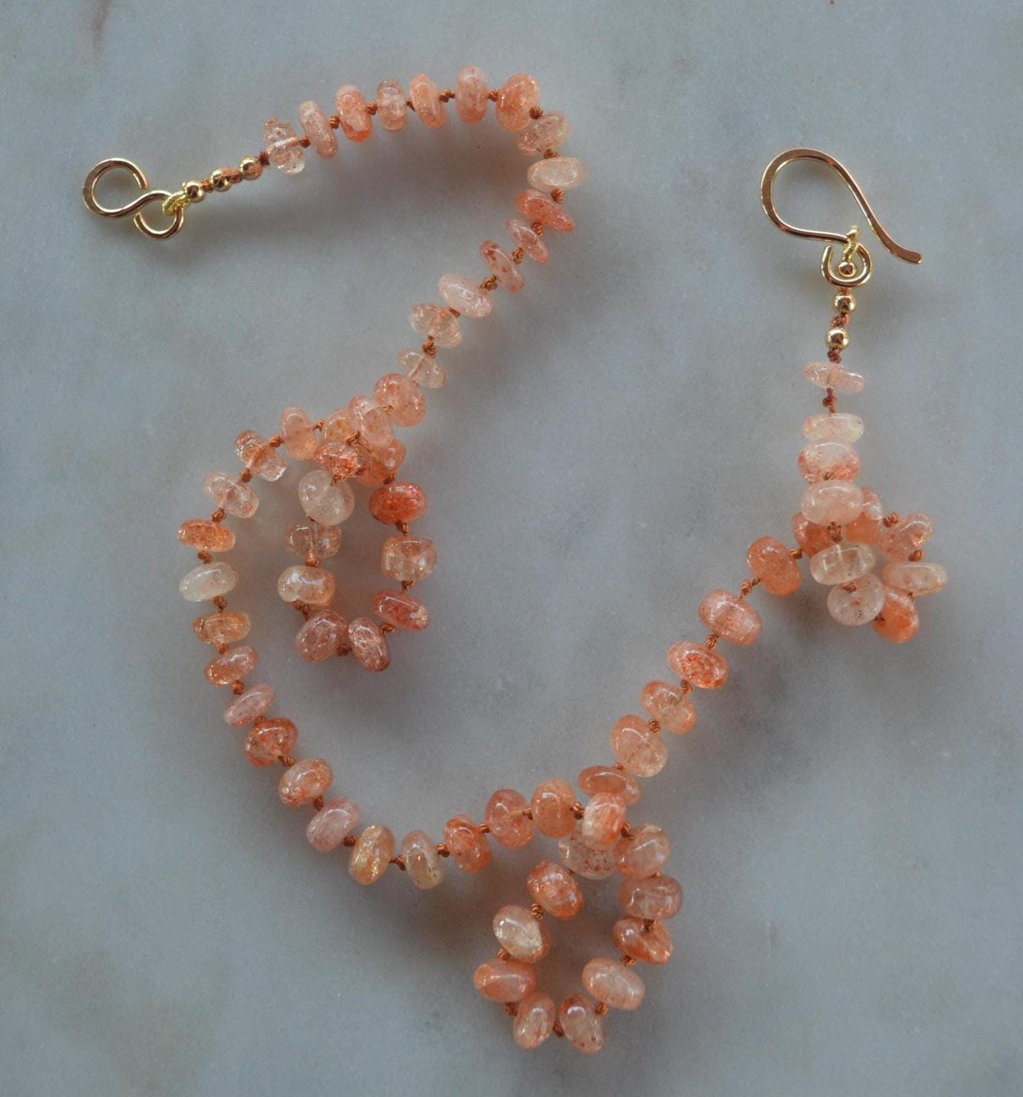 Natural 7mm Sunstone Gemstones Hand Knotted on Coral Silk.  This Piece is Finished with a Hand Forged GF Hook & Eye Clasp. 18.5" Long.
